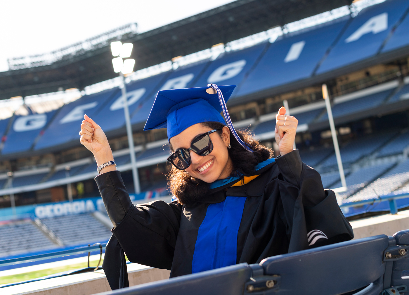 Graduate student celebrating at commencement.